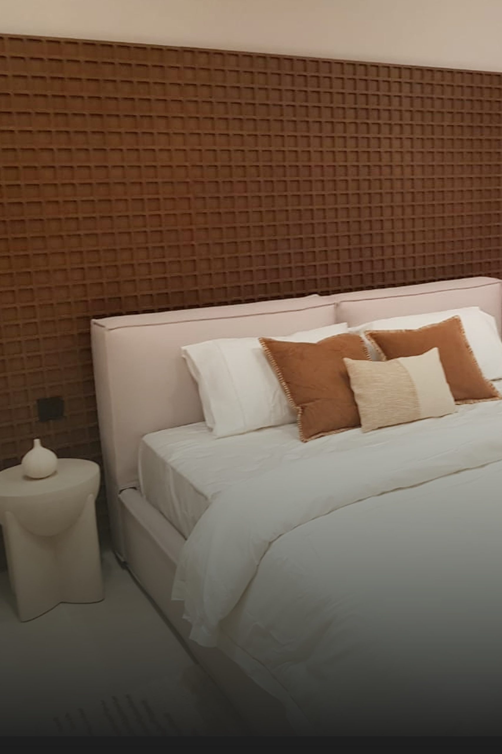 Luxury residential bedroom interior with textured headboard by Southern Interior & Fitout LLC